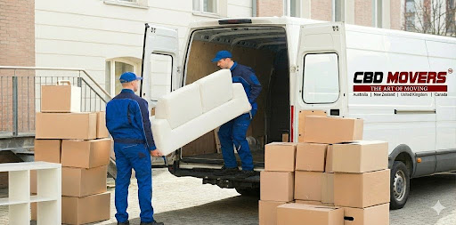 Two uniformed CBD Movers loading a white sofa into a branded truck, representing interstate removalists Melbourne to Sydney services.