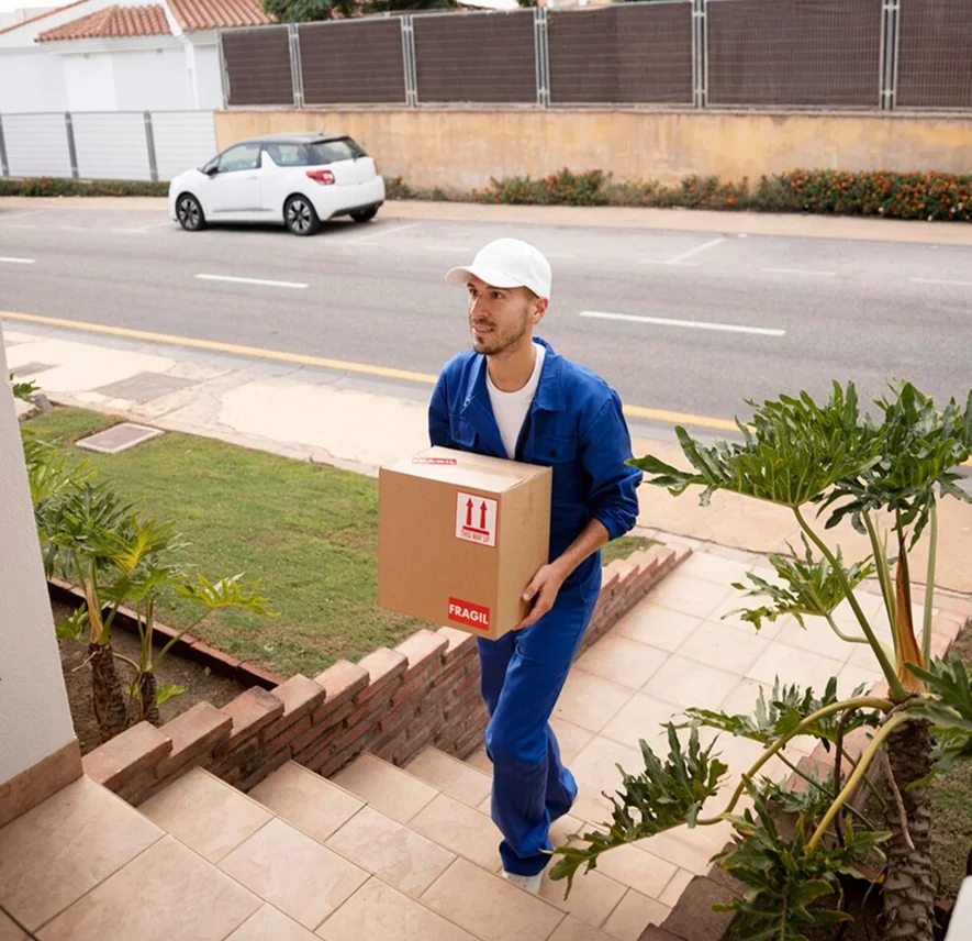 Two CBD Movers removalists loading boxes into a van outside a home