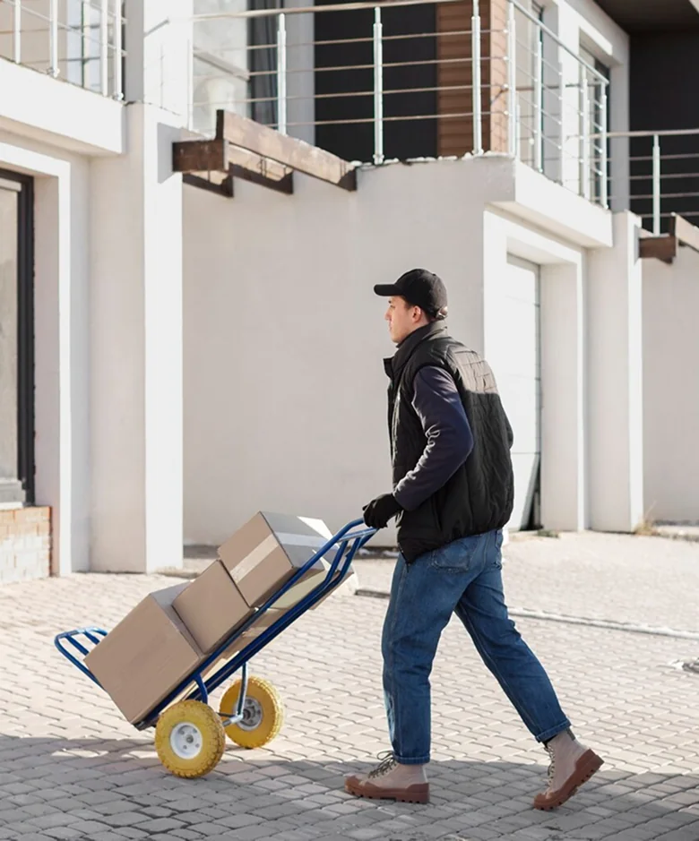 A CBD Movers removalist loading a large box into the back of a moving van
