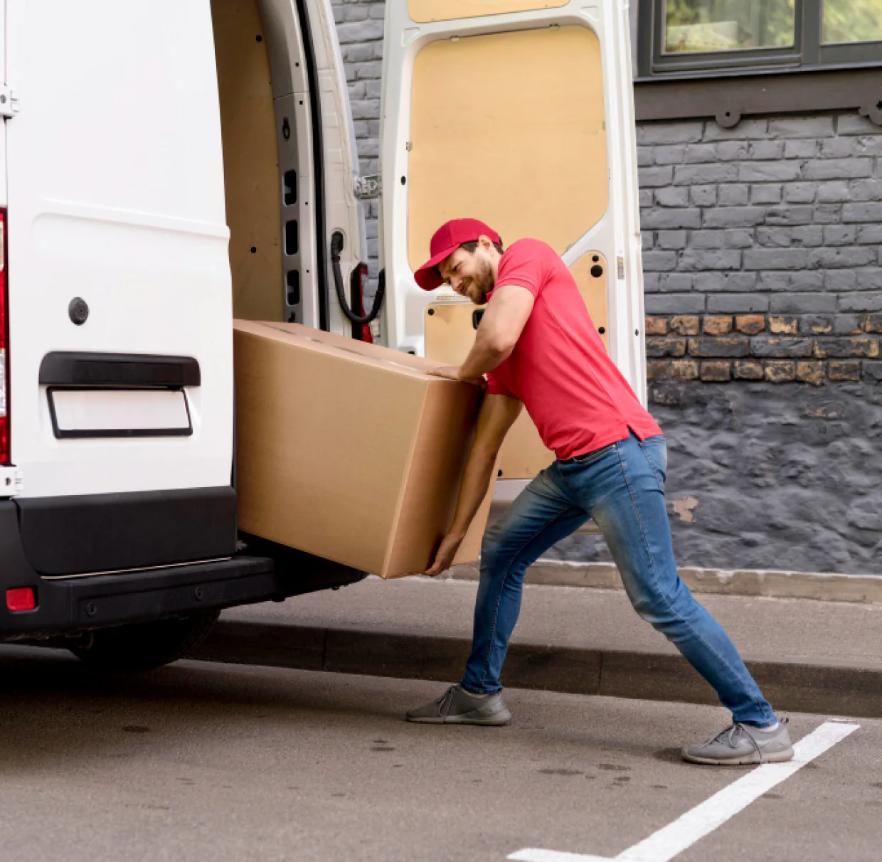 A CBD Movers removalist loading a large box into the back of a moving van