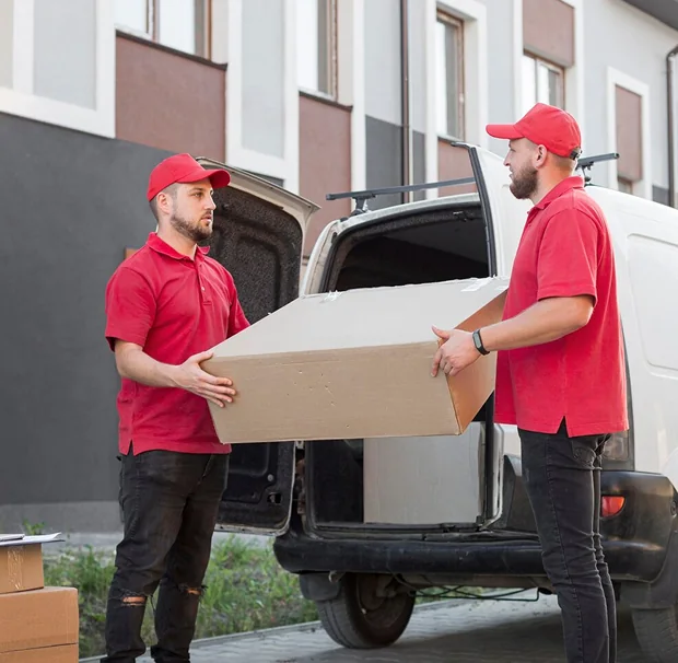 A CBD Movers removalist loading a large box into the back of a moving van